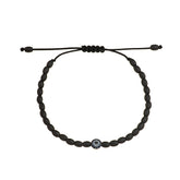 Gold Evil eye bracelet with sapphires and diamonds. Combined with ceramic beads.